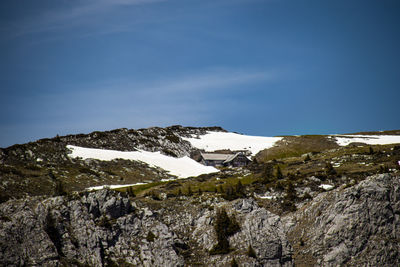 Scenic view of snowcapped mountain against blue sky