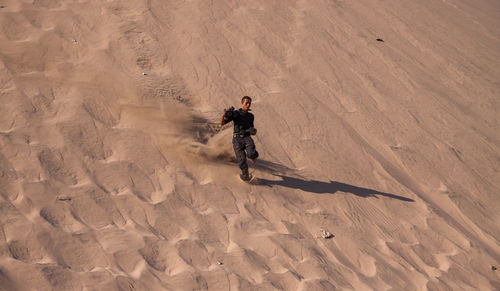 High angle view of man standing on sand