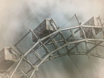 Low angle view of ferris wheel against sky