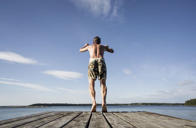 Rear view of mature man diving into sea