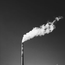 Low angle view of smoke emitting from chimney