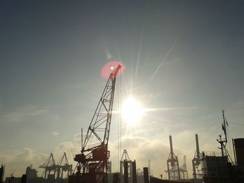 Low angle view of sun shining through clouds