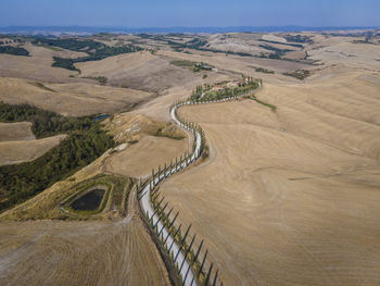 High angle view of road by land against sky