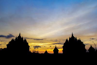 Silhouette of temple building against sky during sunset