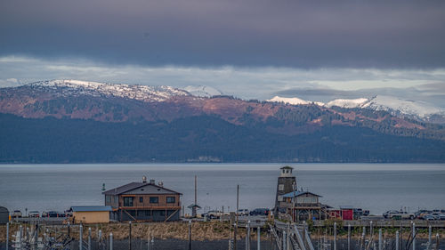 Scenic view of sea and mountains against sky