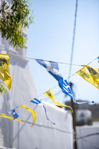 Low angle view of flags against sky mykonos greece