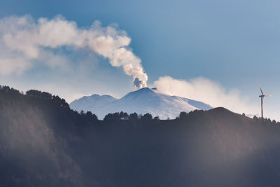 Smoke emitting from volcanic mountain against sky