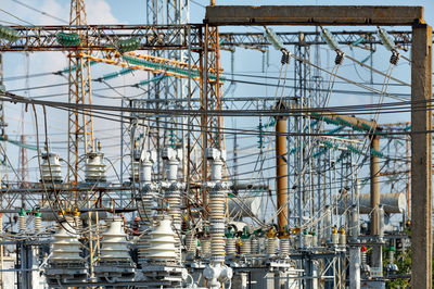 A fragment of an electrical substation with many wires and dielectric insulators.