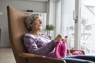 Woman sitting on sofa at home