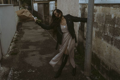 Full length of young woman standing on street