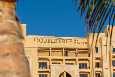 Low angle view of building against clear blue sky