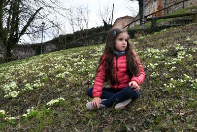 Cute girl sitting on field