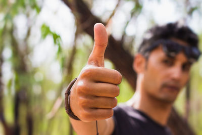 Close-up of young man gesturing outdoors