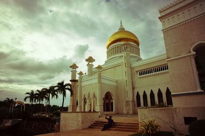 Low angle view of historical building against cloudy sky