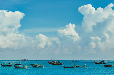 Boats moored in sea against sky