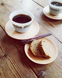 Close-up of coffee cup on wooden table