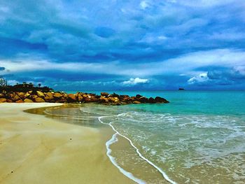 View of beach against cloudy sky