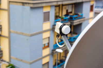 Close-up of telephone booth against building