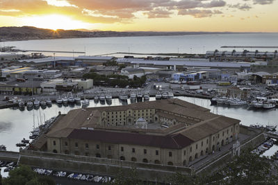 High angle view of townscape by sea against sky