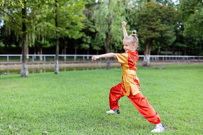 Full length of woman standing on field