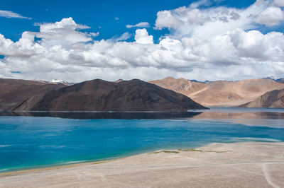 Scenic view of lake and mountains against sky