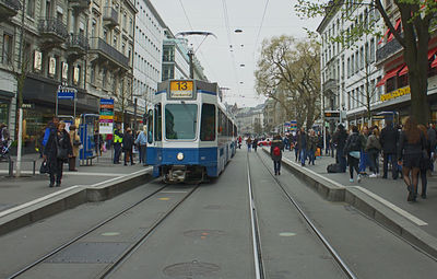 Tramway and people on street amidst buildings