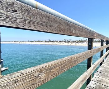 Pier over sea against clear sky