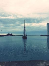 Sailboat sailing on sea against sky