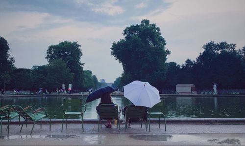 People sitting in park during rainy season