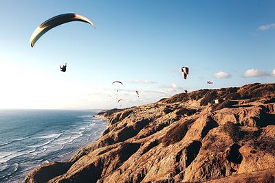 Hot air balloons flying over sea