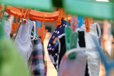 Close-up of multi colored clothespins hanging at market stall