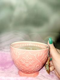 Close-up of hand holding tea cup