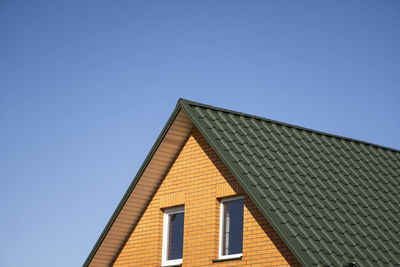 Low angle view of building against clear blue sky