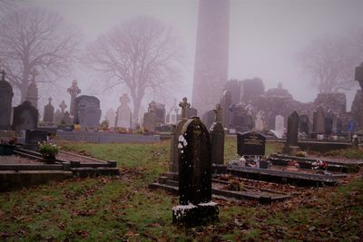 View of cemetery against foggy weather