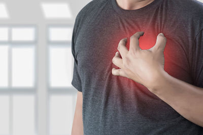 Digital composite image of man suffering from heart pain