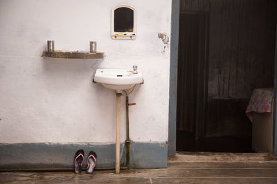 Faucet and sink by doorway outside house