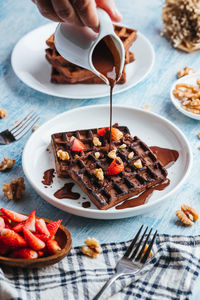 High angle view of person preparing food in plate on table