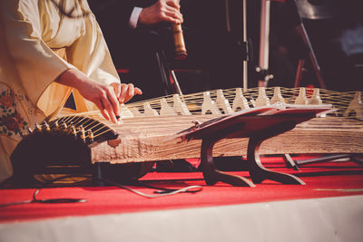 Midsection of woman playing piano