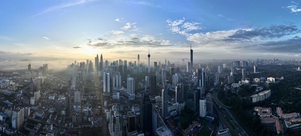 Aerial view of cityscape against sky during sunset