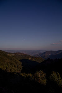 Scenic view of landscape against clear sky at night
