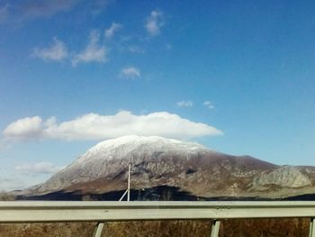 Scenic view of mountains against blue sky