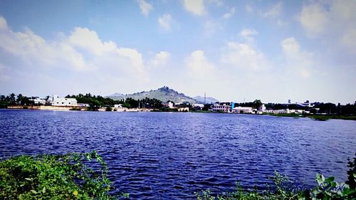 Scenic view of river against cloudy sky