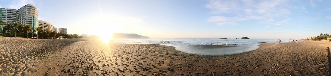 Panoramic view of beach against sky during sunset