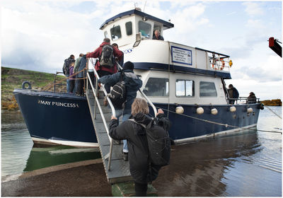 People standing on boat against sky