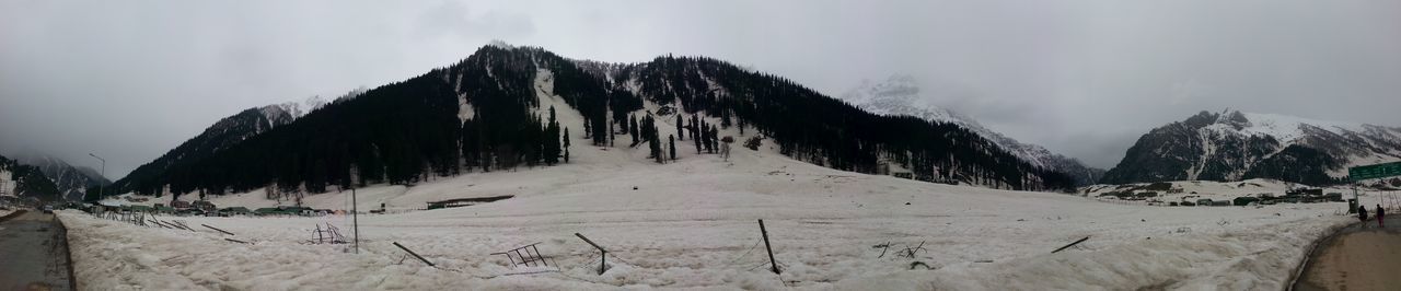 Panoramic view of mountains against sky during winter