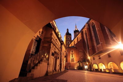 Wawel cathedral seen through illuminated tunnel at dusk