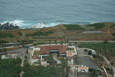 High angle view of houses by sea against buildings