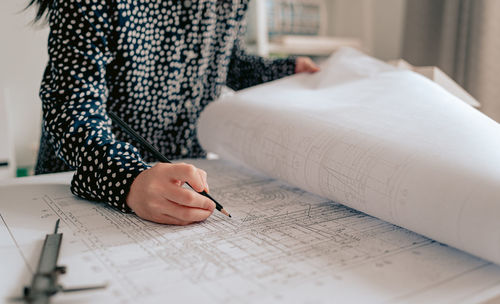 Midsection of person holding paper