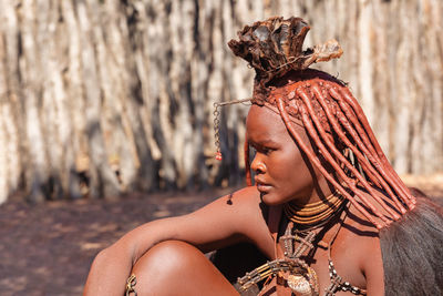 Portrait of young woman sitting outdoors
