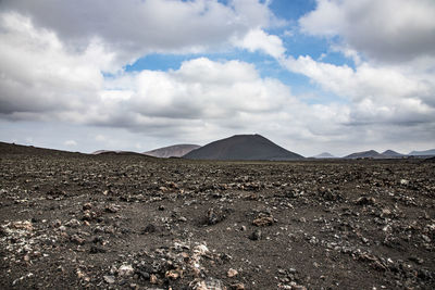 Scenic view of arid landscape against sky